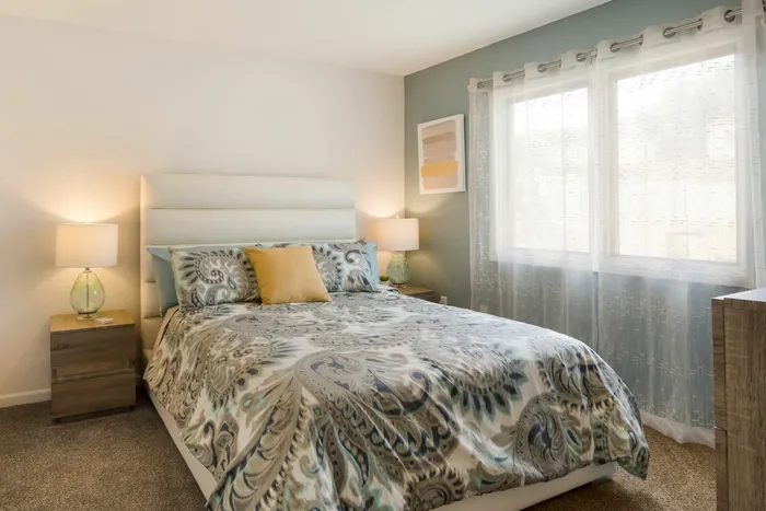 Carpeted bedroom in apartment at at Liv Wildwood apartments in Ludington, Michigan.