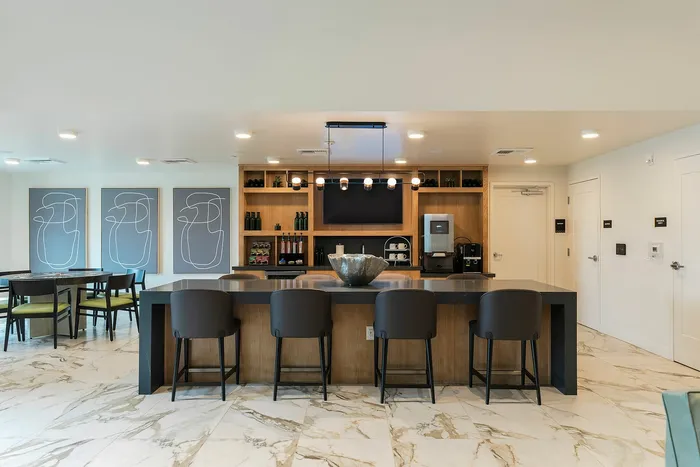 Stylish modern lounge area with sleek bar seating and contemporary artwork Tastefuly decorated lounge with comfortable | Liv+ Union Peak | Phoenix, Arizona