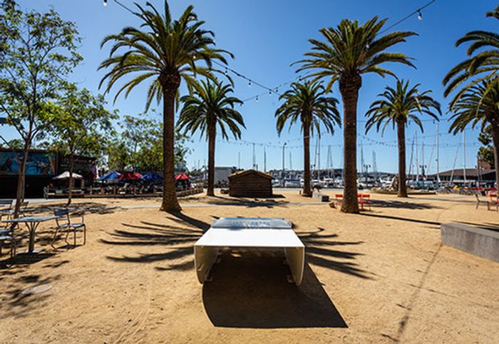Image of beach front with sand and seating areas