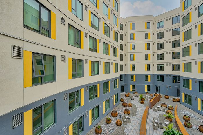 Oakland, CA Apartments - Exterior View of Channel House Apartments Building with View of Outdoor Pathway