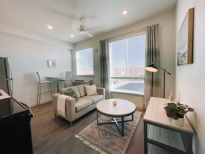 Colfax style unit living room area with kitchen and high-top bar table