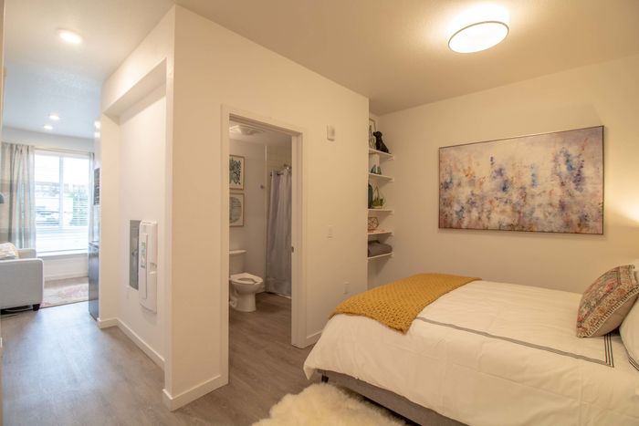 Bedroom with centered bathroom
