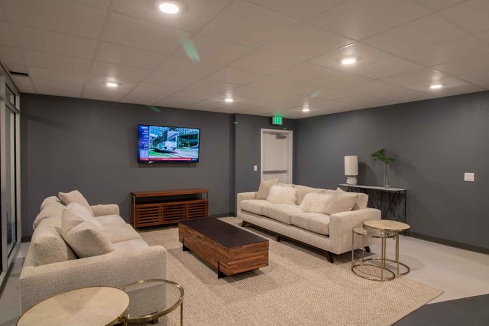Lounge space with two couches and one TV