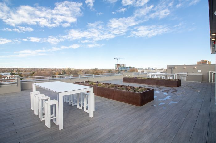 rooftop lounge with seating space overlooking Downtown Denver