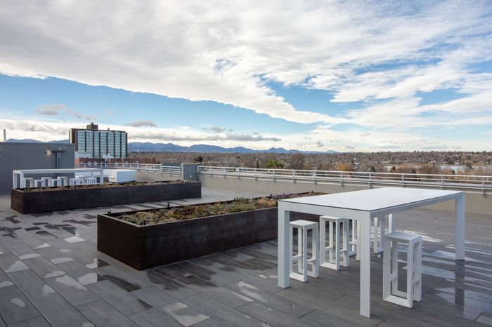 rooftop lounge with seating space overlooking the mountains