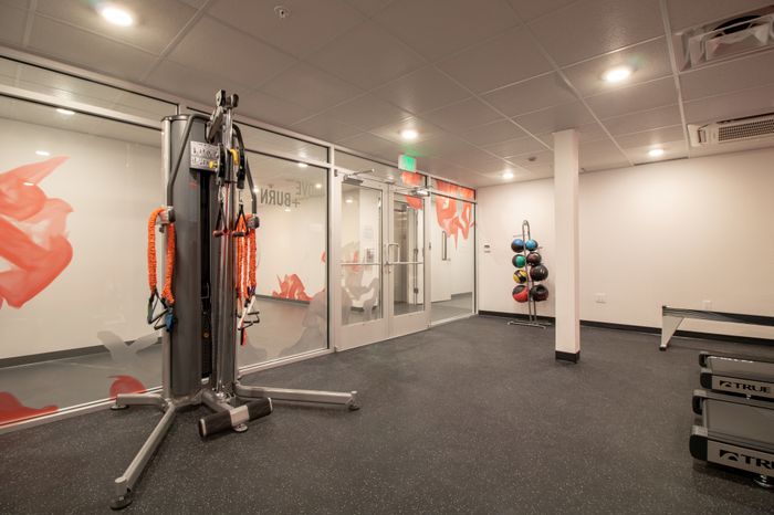 Fitness center with multiple workout machines and free weights