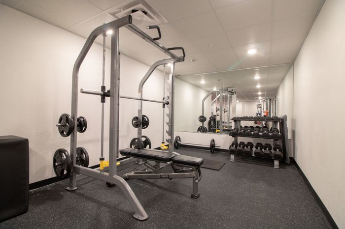 Fitness center with a benchpress machine and free weights