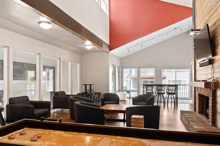 Inviting lounge area with cozy seating, modern decor, and abundant natural light, perfect for relaxation and entertainment.