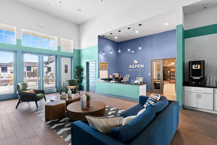 Stylish and welcoming lobby of Aspen Heights, featuring modern seating, vibrant decor, and ample natural light.