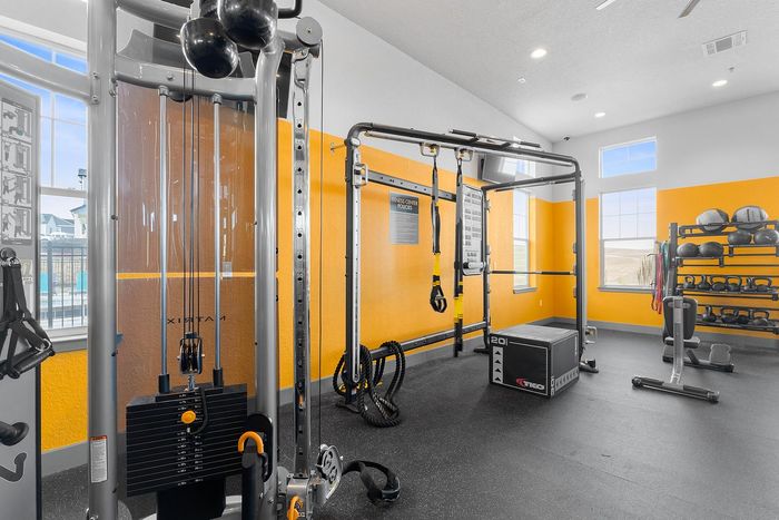 Bright and modern fitness center with state-of-the-art equipment, including weights and cardio machines.