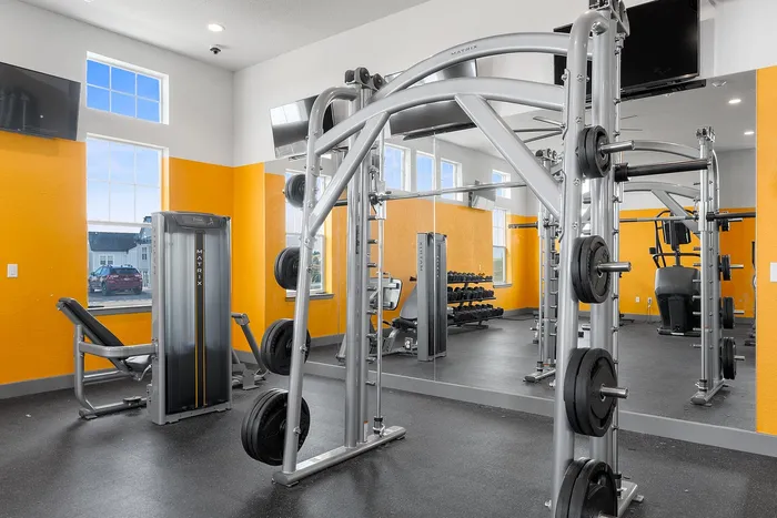 Bright and modern fitness center with state-of-the-art equipment and vibrant orange accents.