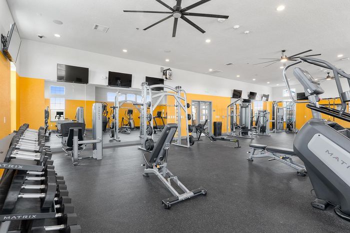 Spacious and modern gym facility with top-tier equipment, featuring an array of strength and cardio machines.