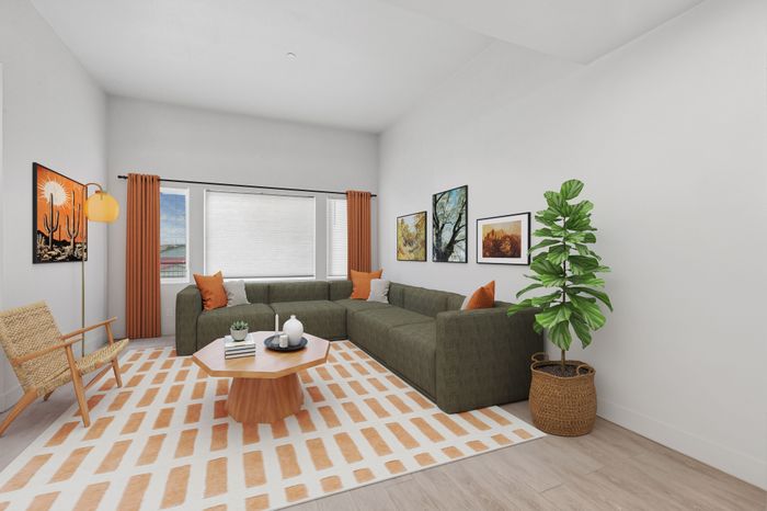 Contemporary living room with a stylish olive green sectional sofa, vibrant orange accents, modern art pieces, and a lush potted plant on sleek hardwood floors.