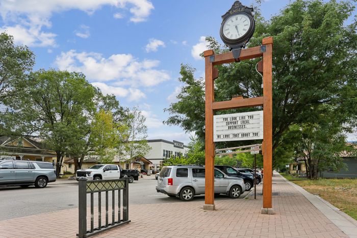 Charming streetscape featuring a classic outdoor clock and inviting local businesses in a vibrant community setting.