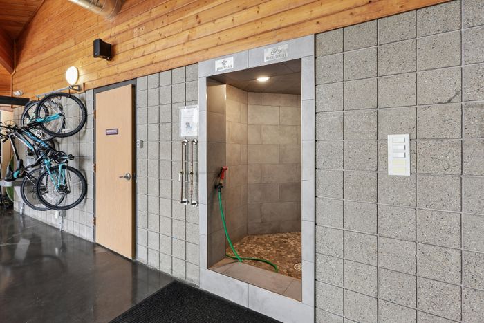 Modern pet and bike wash station in an apartment complex with sleek tile design and convenient bike storage.