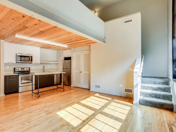 Open area with staircase and modern kitchen at The Fox Building.
