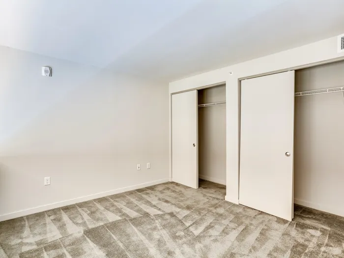Empty loft bedroom showcasing closet space at The Fox Building.