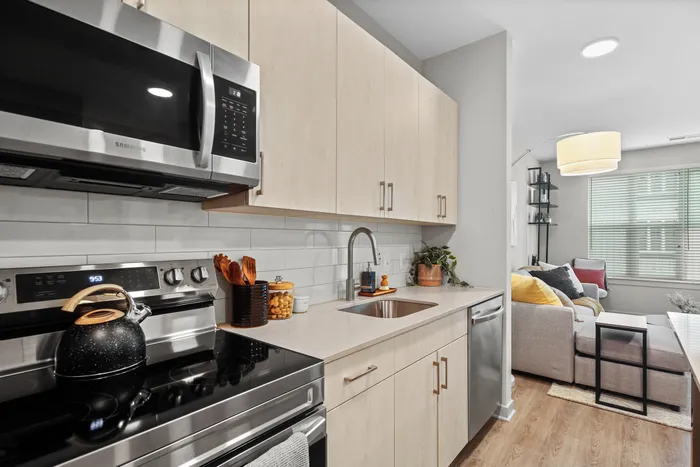 Sleek kitchen featuring stainless steel appliances and microwave at Yard 56 Lofts.