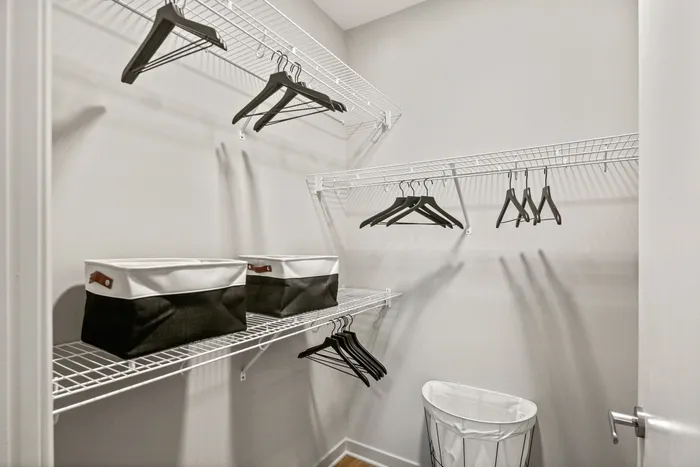 Neatly arranged clothes on shelves inside a closet at Lofts at Yard 56.
