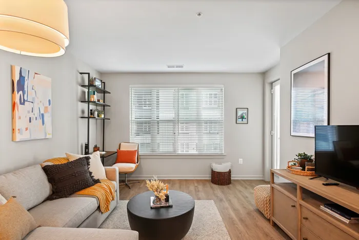 Lofts at Yard 56 living room with a comfy couch, a stylish coffee table, and a sleek television.