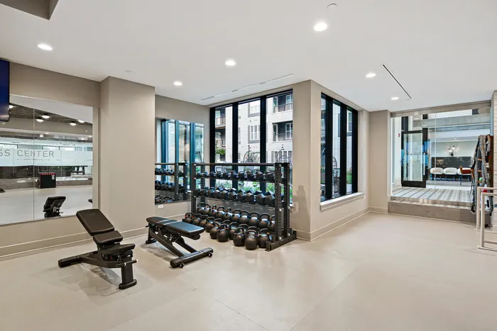Lofts at Yard 56 fitness center with weights and exercise gear.