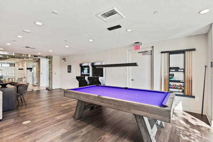 A billiard table in a game room at the park. Play a game of pool and have fun with friends and family at Lofts at Yard 56!