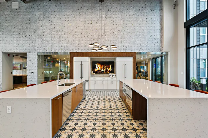 Kitchen with fireplace and spacious island at Lofts at Yard 56.