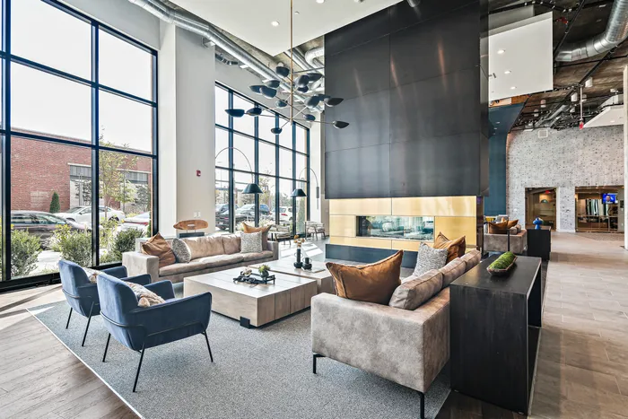 Cozy fireside lounge and large windows at Lofts at Yard 56.