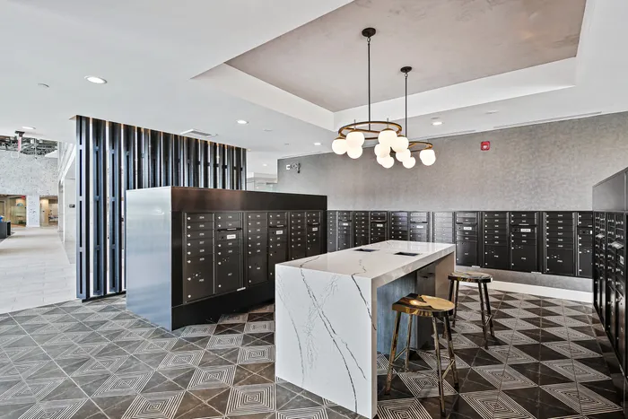 The lobby of Lofts at Yard 56 with a spacious desk and lockers. A welcoming entrance for visitors and a secure storage area for belongings.