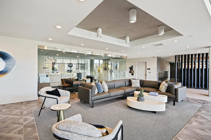 A modern living lounge at Lofts at Yard 56 with a large round table, perfect for gatherings and conversations.