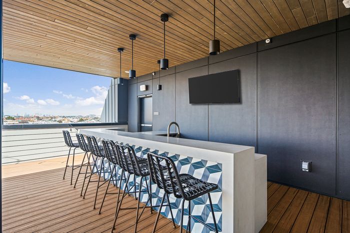 A kitchen with a rooftop bar, perfect for entertaining and enjoying the view.at Lofts at Yard 56.