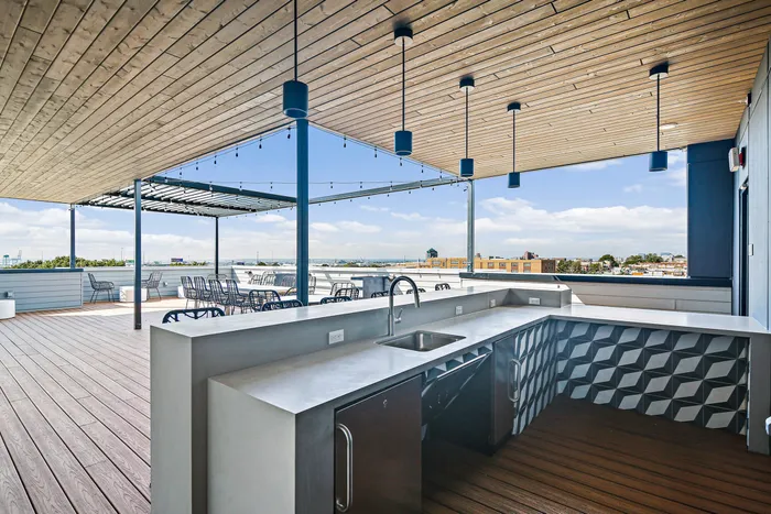 A kitchen sink and counter on a deck, perfect for outdoor cooking and enjoying the fresh air at Lofts at Yard 56.