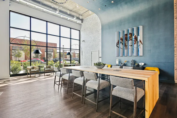 Spacious kitchen with big dining table in lobby lounge at Lofts at Yard 56.