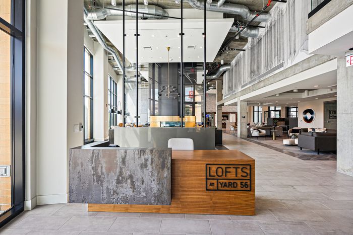 A spacious reception desk and a big window overlooking the area at Lofts at Yard 56.