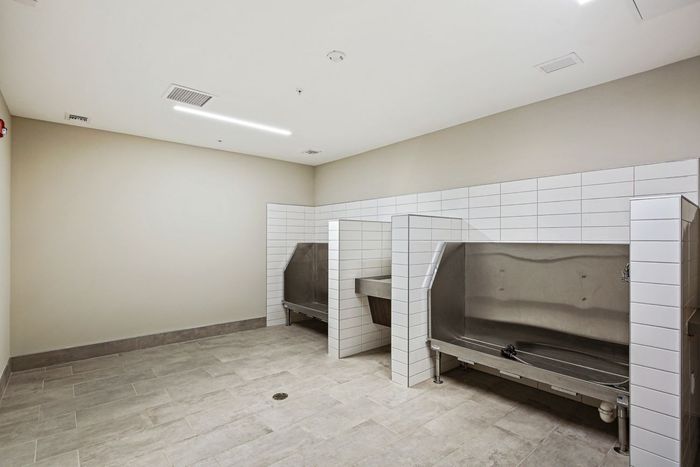 Dog washing station at Lofts at Yard 56 with raised platform, hose, and sink for convenient, clean pet care.