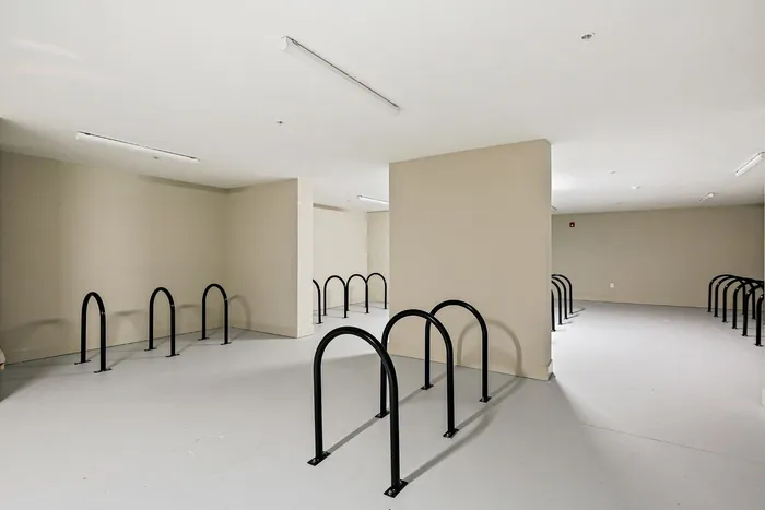 A well-organized room with a bike rack displaying a couple of bikes, ideal for cycling lovers and urban dwellers at Lofts at Yard 56.