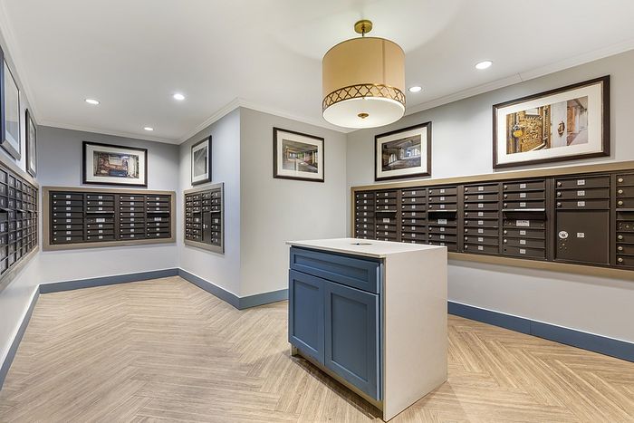 Modern apartment mailroom with elegant decor and organized mailbox units.