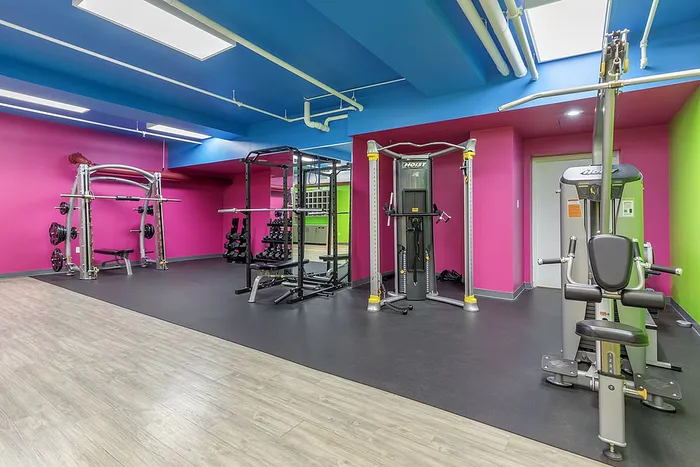 Bright gym with fitness equipment and colorful walls