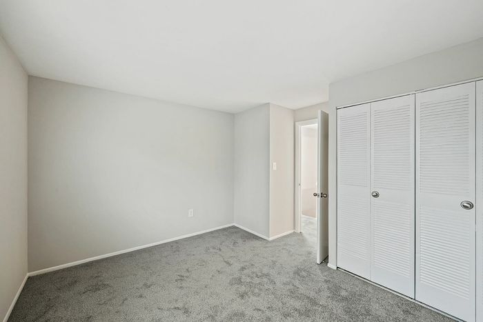 Bright and airy bedroom with plush carpet and ample closet space.
