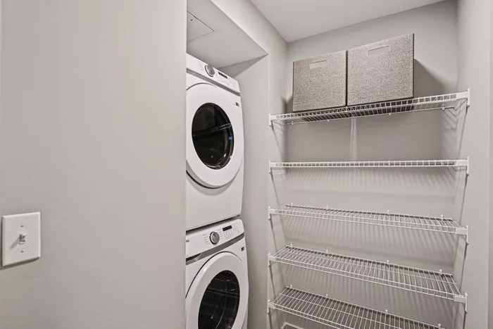 Laundry room at Lofts at Yard 56 featuring a washer and dryer, neatly arranged for convenience and efficiency.