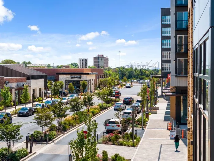 City street scene featuring cars and buildings, with the Lofts at Yard 56 prominently in the background.