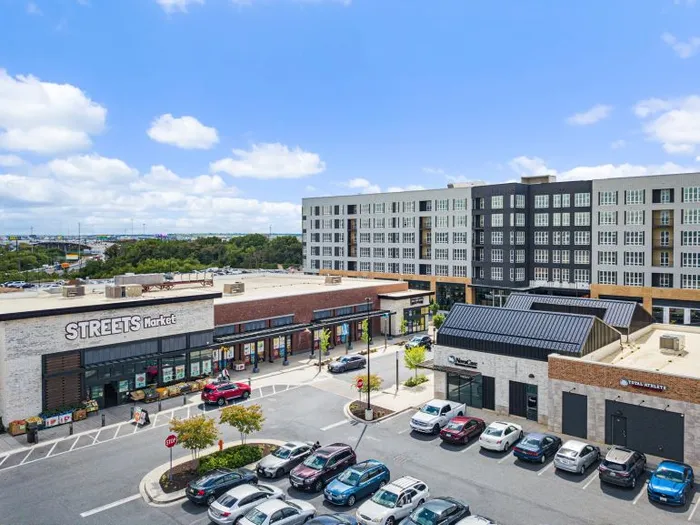 Lofts at Yard 56 at street corner and parking lot, showcasing modern apartment architecture.