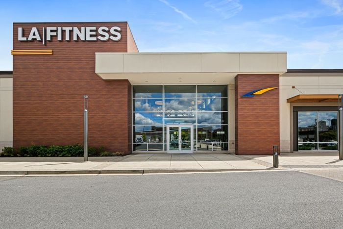 Front view of LA Fitness near Lofts at Yard 56, highlighting the gym's entrance and logo.