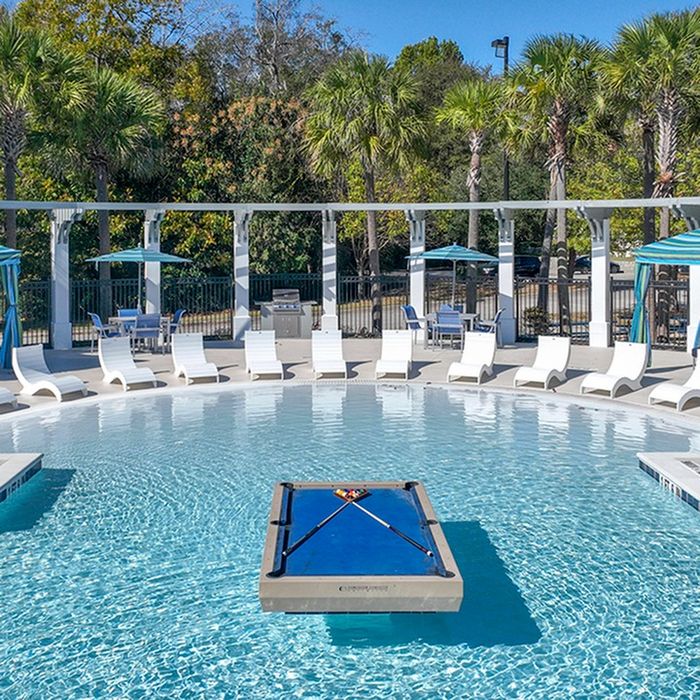 the hudson statesboro student housing pool view with lounge chairs and pool table