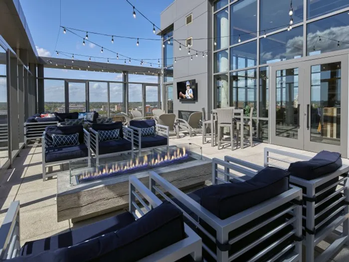 outdoor seating area with fire pit and tvs six11 ann arbor