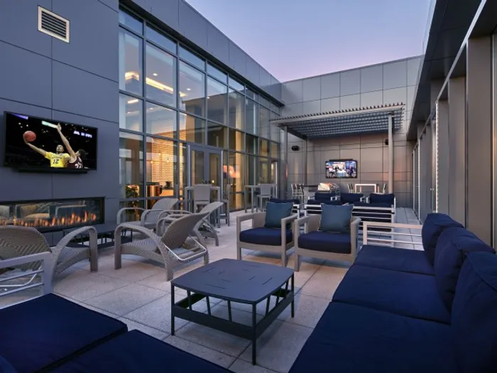 outdoor seating area with tvs and fire place six11 ann arbor
