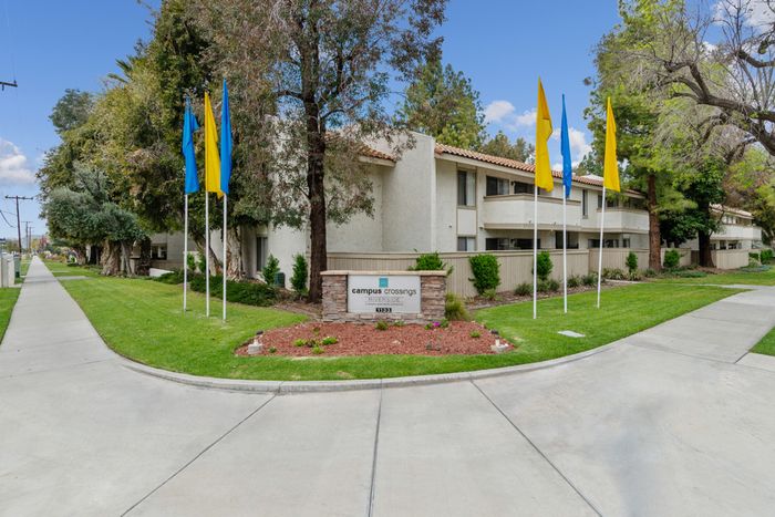 campus crossings riverside apartments entryway with sign