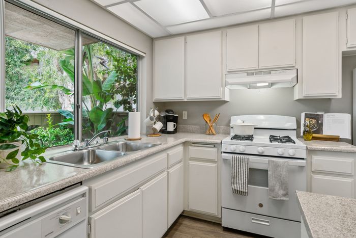 campus crossings riverside model unit kitchen with dishwasher, sink, and oven.