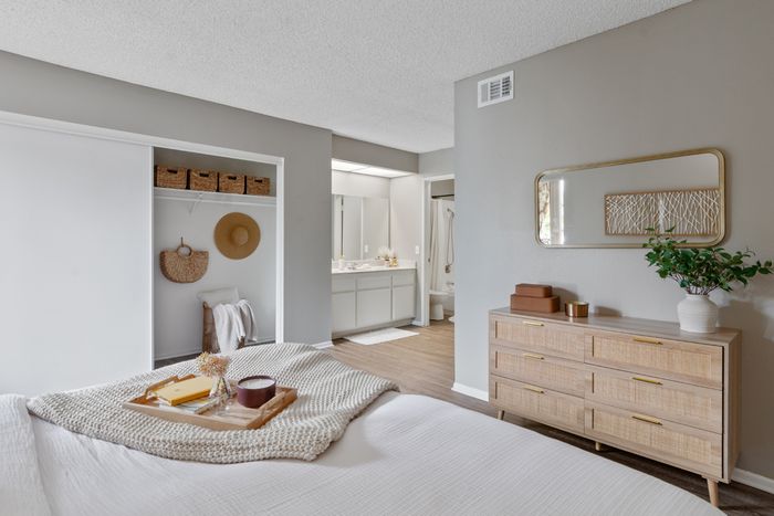 campus crossings riverside model unit bedroom with dresser and closet.