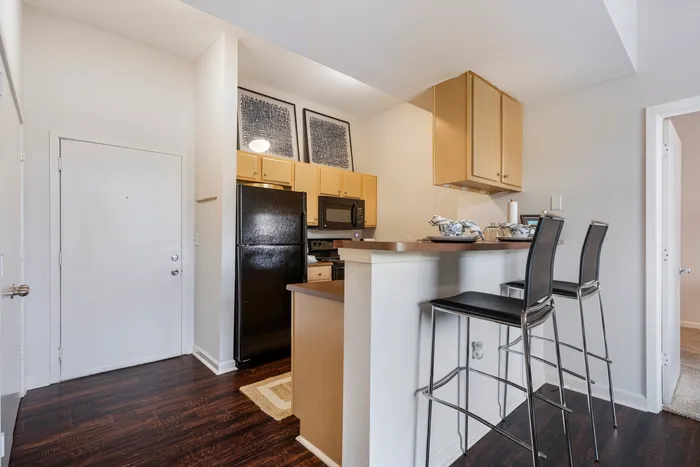 kitchen in model unit with stools and appliances campus crossings on highland baton rouge